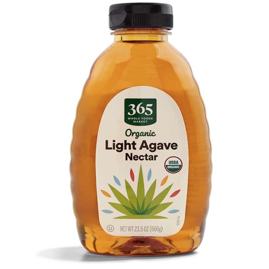 A 23.5 oz (666g) bottle of 365 Whole Foods Market Organic Light Agave Nectar, perfect for sweetening your strawberry basil cocktail. The clear bottle, capped in black, boasts a vibrant agave plant illustration and proudly displays its USDA Organic certification.